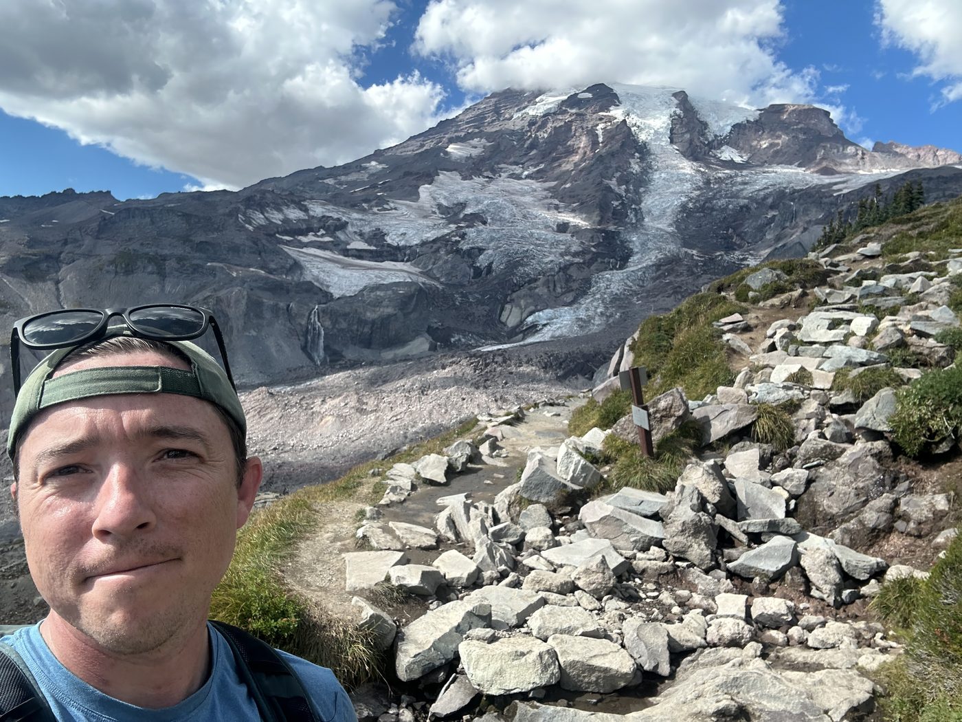 On a rocky trail with Mt. Rainier in the background